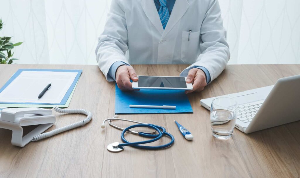 Professional doctor working at office desk