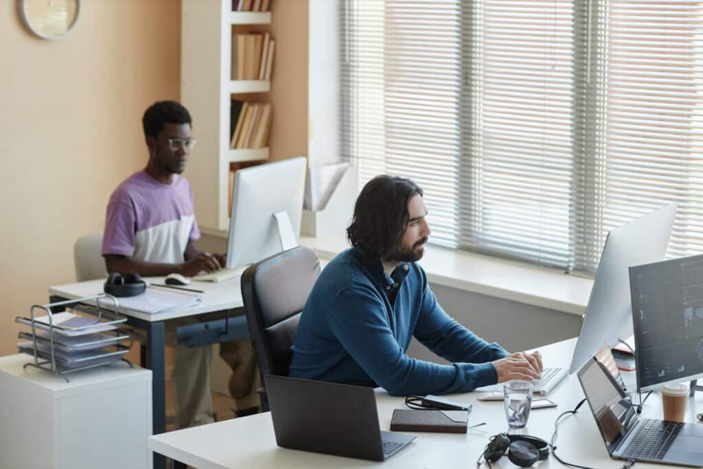 man pressing keys of computer