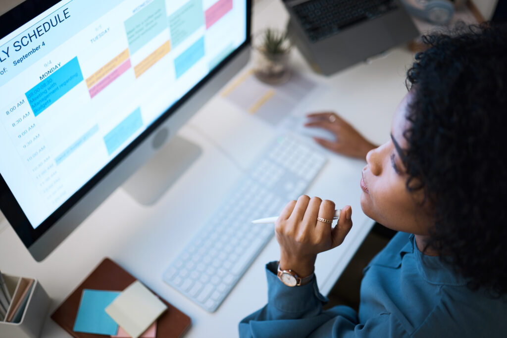 Woman with computer, thinking and checking schedule, agenda and reminder for office administration