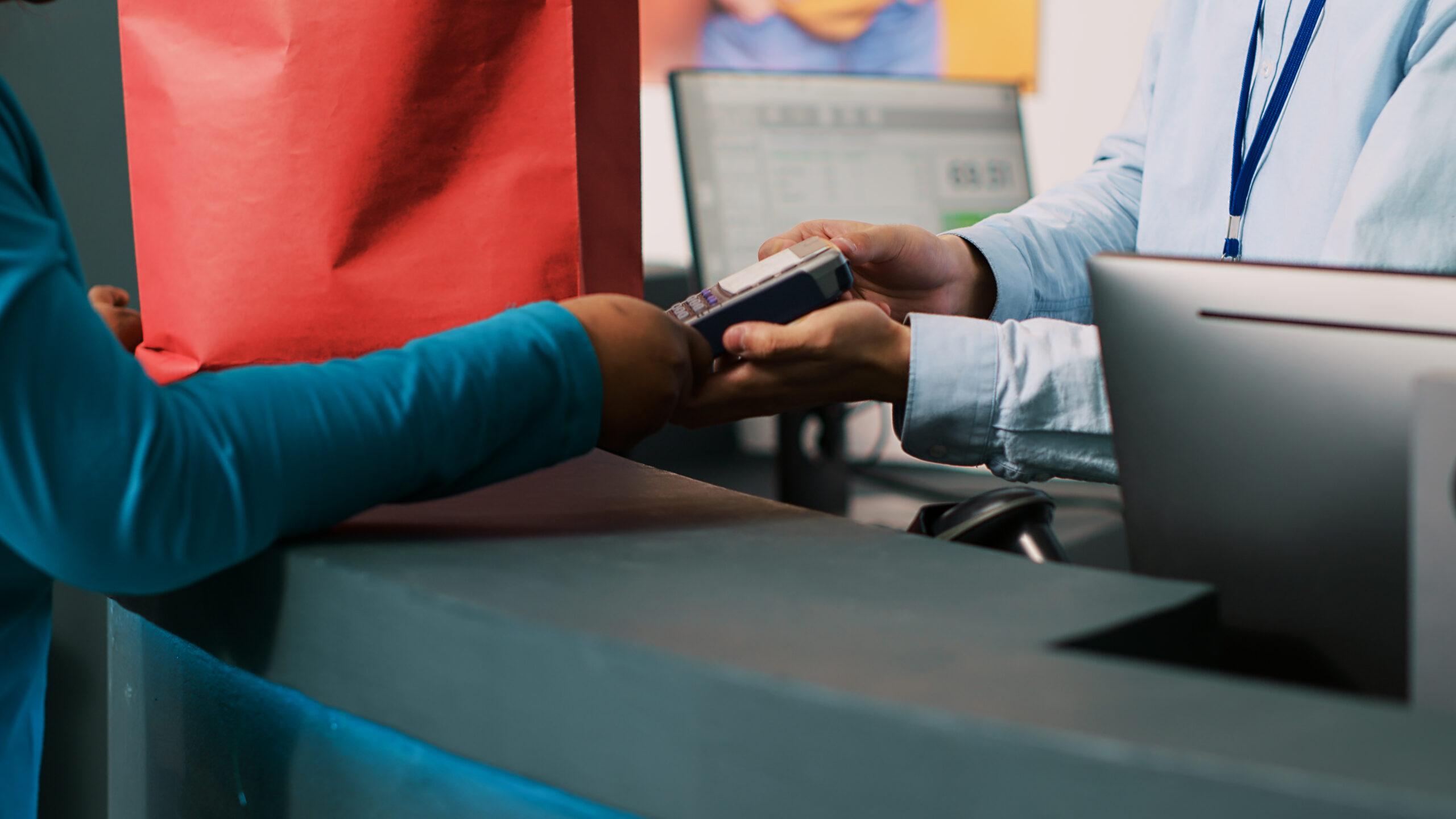 Customer using a digital payment terminal to round up a purchase for charity through an automated bank checkout system.